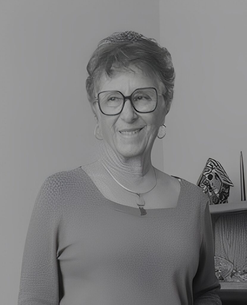 Smiling woman wearing glasses and necklace