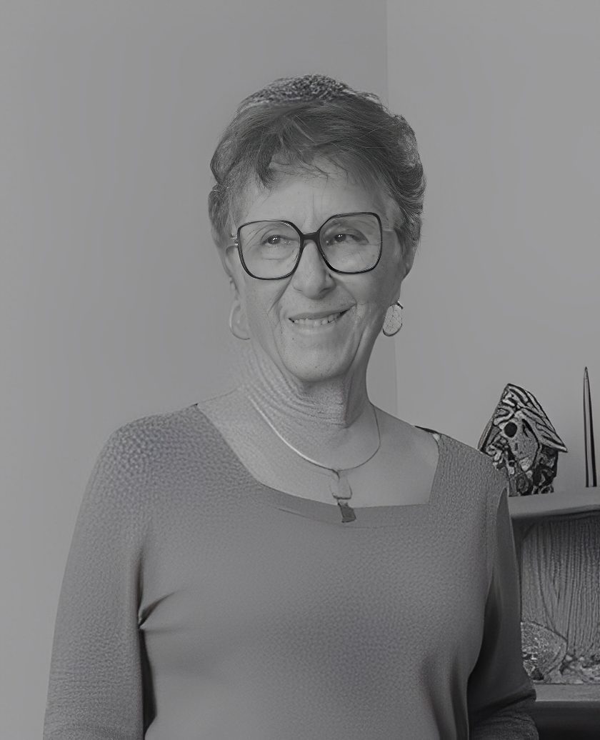 Smiling woman wearing glasses and necklace