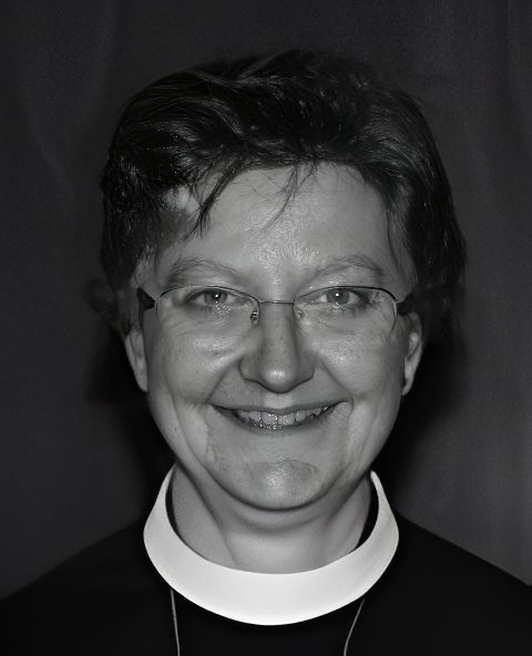Smiling person wearing clerical collar portrait