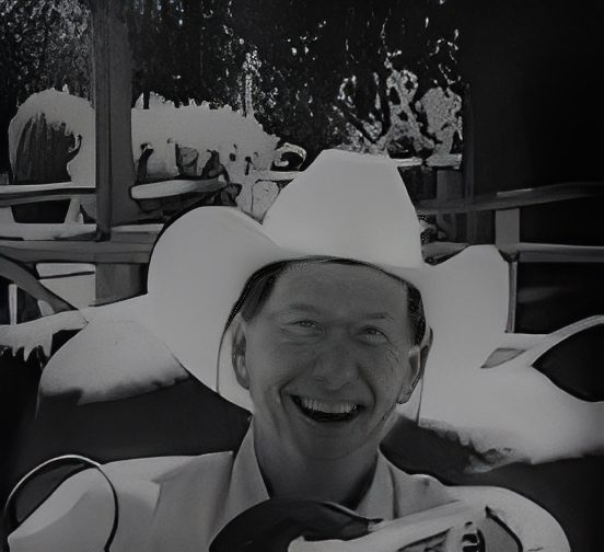 Smiling man in cowboy hat in snow