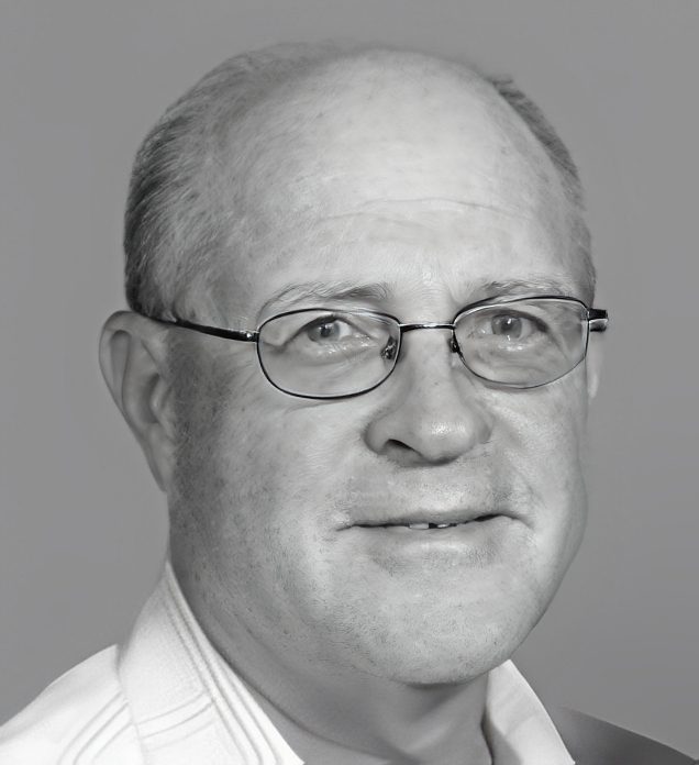 Headshot of person wearing eyeglasses, neutral background