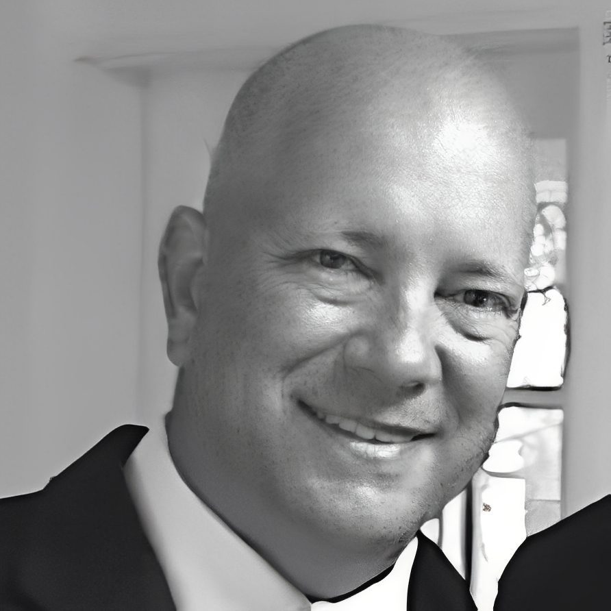 Smiling bald man in suit, indoor portrait