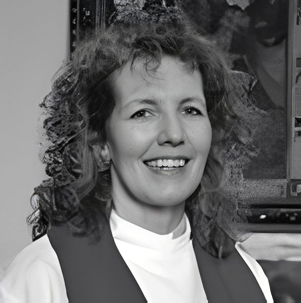 Smiling woman wearing clerical collar and stole