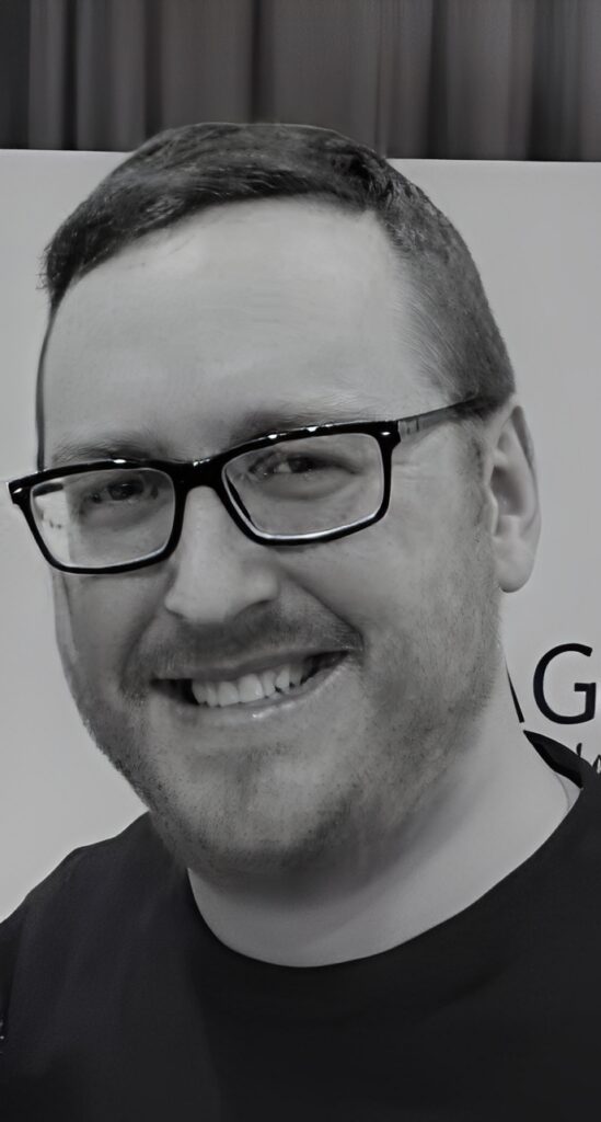 Close-up portrait of smiling man with glasses